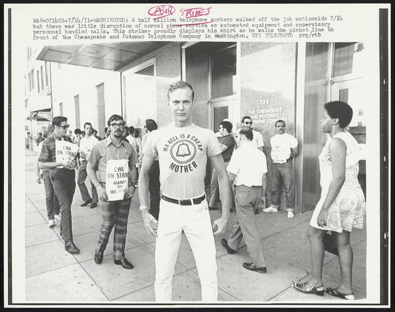 A half million telephone workers walked off the job nationwide 7/14 but there was little disruption of normal phone service as automated equipment and supervisory personnel handled calls. This striker proudly displays his shirt as he walks the picket line in front of the Chesapeake and Potomac Telephone Company in Washington.