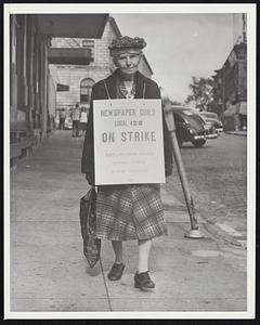Oldest Striker Miss Brenda Sinkinson, 80-year-old proof reader, walks picket line at Portland, Me., where the CIO American Newspaper Guild's Portland unit is on strike at the Gannett Publishing Company's three newspapers. (9/29/53) She is oldest of 180 employes involved.