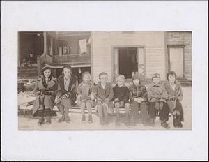 Neighborhood children sitting on a sled in front of the Stefanic home