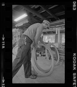 Ralph Johnson with wooden hoops in Pert Lowell's boat shop