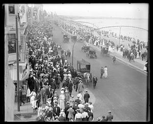 A crowded sidewalk by a beach