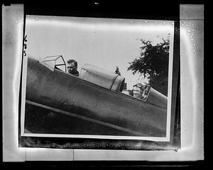 Charles Lindbergh and an unidentified man in the cockpit of an airplane