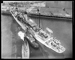 Presidential yacht Mayflower from above with tugboats beside it