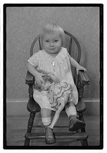 A girl holding a doll