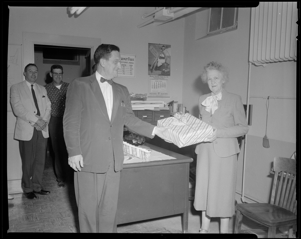 Mrs. Frances Fuller Colby at her retirement party, receiving a gift from Selectman Victor F. Adams.