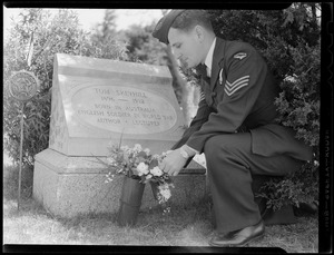 Australian WWII pilot Sgt. Allen Catip at West Dennis Cemetery decorating Tom S. Skeyhill’s grave