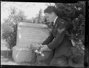 Australian WWII pilot Sgt. Allen Catip at West Dennis Cemetery decorating Tom S. Skeyhill’s grave