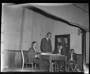 Group of men on stage/platform with law books