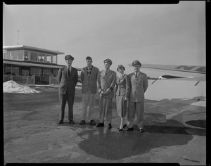 Airport scene, group of four men and a woman