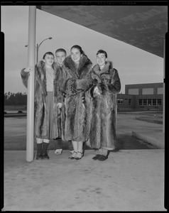 Group wearing fur coats