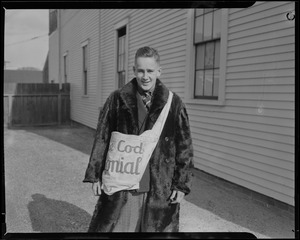 Unidentified young man in fur coat with Cape Cod Colonial bag