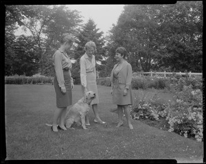 Three unidentified women with dog