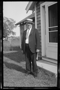 Unidentified man in suit and straw hat