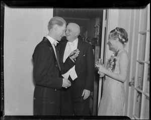 Three unidentified people (two men and a woman) in formal dress