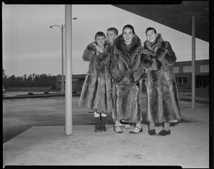 Unidentified girls in fur coats with boy