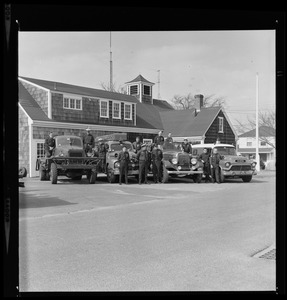 Uniformed men with Barnstable District fire trucks