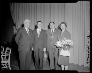 Victor Adams with two unidentified men and a woman with bouquet