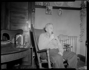 Unidentified man in rocking chair with pipe