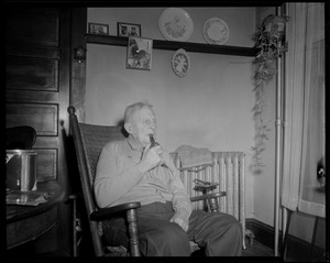 Unidentified man in rocking chair with pipe