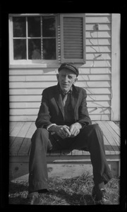 Unidentified older man seated on porch