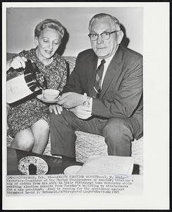 Awaits Election Results--I.W. Abel Secretary-Treasurer of the United Steelworkers of America, receives a cup of coffee from his wife in their Pittsburgh home Wednesday while awaiting election results from Tuesday's balloting by steelworkers for a new president. Abel is running for the presidency against incumbent David J. McDonald.