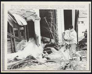 Robert L. Bradshaw, 17, removes the belongings he can find from the second floor--now resting on the ground--of his house, torn apart by Hurricane Camille, 8/18.