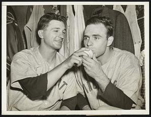 A Kiss for Winning Ball. Pitcher Johnny Vander Meer, (right) Who won his own game that clinched the second straight national League flag for the Cincinnati Red in Philadelphia Sept. 18, plants a kiss on the last ball hurled across the plate by pitcher Joe Beggs (left), who replaced Vandy in the 13th and set the enemy down in order. Vander meer doubled in the 13th and scored the winning run.