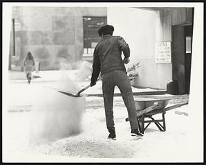 Throwing sand on sidewalk on Berkeley St. Weather snow