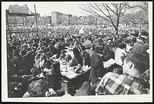 Youths' (center foreground) sign up membership in draft resistance-movement during rally on Boston Common.