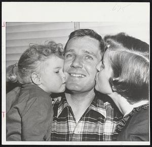 Pitcher Jack Sanford of the Philadelphia Phils and a native of Wellesley is properly awarded with kisses by his wife and daughter on winning the National League Rookie of the Year award. Sanford had a 19-8 record.