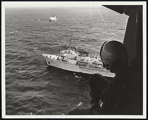 Observer seated in hatch of an Air For[ce] [illegible] gets a bird's-eye view of one of the ships in scientific array off the Barbados coast.