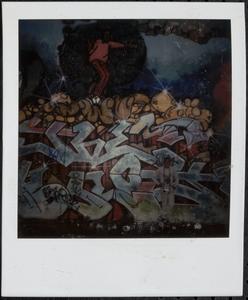 Boy in front of graffiti wall