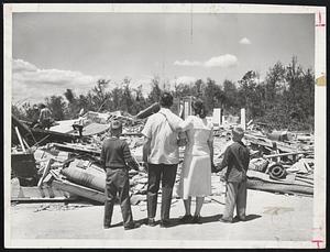 Surveying the Wreckage of their home on Brentwood Drive, Holden, are Mr. and Mrs. Raymond L. Myers and their sons, Raymond, Jr., 10, and Gregory, 8. Mrs. Myers spent three days in a hospital with a broken rib.