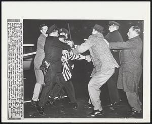 Anti-Communist Demonstrator Subdued--Police grapple with one of anti-Communist pickets as fights broke out during demonstration outside Park Avenue headquarters of Soviet delegation to the United Nations here tonight. Several demonstrators and policemen suffered cuts and bruises as approximately 600 pickets crashed through a line of 200 police. Pickets were sponsored by Hungarian Federation of Former Political Prisoners.