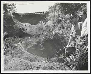 Two Died in Landslide Here-Both Buckland highway department employees, Winsek Sabin of Shelburne Falls, and Harold Clark, perished when this great mound of earth tumbled from the railroad track bed above. When this photograph was taken the boy of Clark still was in the avalanche. State Trooper Norman Spafford, above, directed the recovery of the bodies.