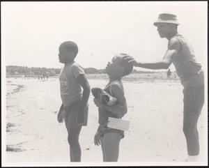 Three boys playing at the beach