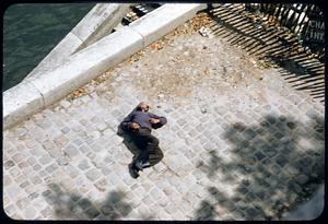Man asleep on pier, Paris