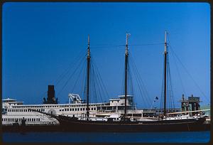 Side view of two boats at pier with Sausalito sign, San Francisco Maritime Museum