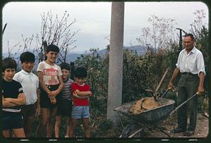Children and man with wheelbarrow, Roccasicura, Italy