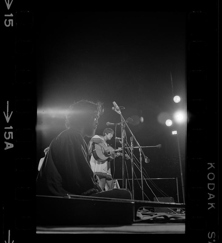 A pregnant Joan Baez sings at Harvard Stadium, Brighton