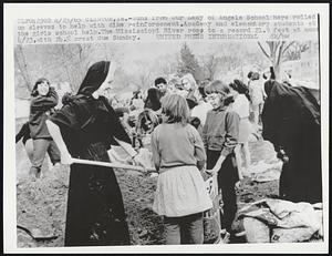 Nuns from Our Lady of Angels School here rolled up sleeves to help with dike reinforcement. Academy and elementary students at the girls school help. The Mississippi River rose to a record 21.9 feet at noon 4/23, with 24.5 crest due Sunday.