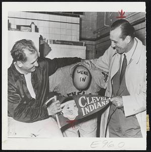 Vic Wertz, Who Lost Scalp in Earlier Raids, provides convenient sign board for the pennant winning Indians to scrawl "We're in." On top of old baldy are happy Manager Al Lopez (left) Hank Greenberg, club general manager.