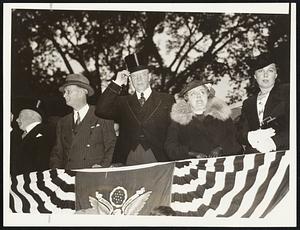 In the mayor's reviewing stand watching the long procession of the Constitution Day parade as it filed past Tremont street, opposite West street. Left to right: Charles E. Eldridge, former mayor of Somerville; Mayor and Mrs. Mansfield; and Miss Mary C. Thompson, the mayor's secretary.