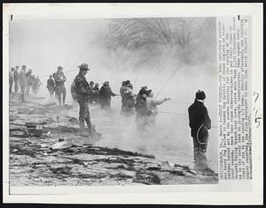 Lebanon – Trout Fishing – The Hard Way – Cold weather and heavy fog failed to dampen the spirits of these anglers as Missourians turned out by the scores Saturday for the opening of the trout season. Here they stand elbow-to-elbow to wet their lines in Bennett Spring Branch near here, where more than 1,100 fishermen showed up to try their luck in 31-degree temperatures. Many caught their limit of six in the opening 1/2 hour. Shortly afterward, one luckless angler observed, the fish retreated to keep from being stepped on.