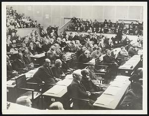 As Geneva Listen to Britain's Voice. Intent, all eyes upon the speaker--even as the eyes of the civilized world were upon them--delegates at the League of Nations assembly here today are seen as they heard the powerful voice of Great Britain demand peace, through her Foreign Secretary, Sir Samuel Hoare; and a few moments later to Tecle Hawariate, Ethiopian spokesman, who proclaimed his empire's "trust in God" and desire for peace.
