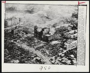 Quake Wrecks Fukui--This aerial photograph shows all that is left of a section of the Japanese city of Fukui, ravaged by an earthquake June 28. the building in the center, leaning precariously and its center sagging, housed the Daiwa department store. Rubble marks the site of many buildings in the neighboring which were demolished.