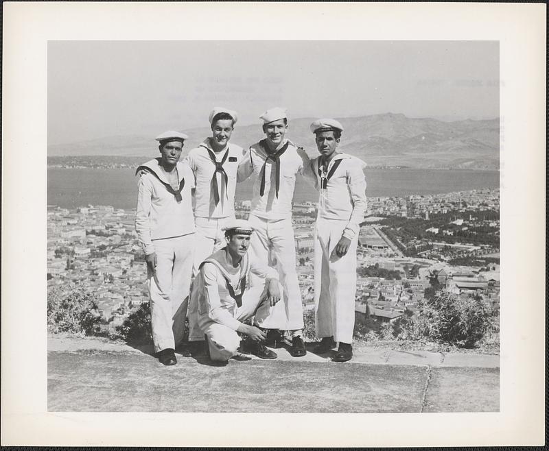 R. E. Burdick, storekeeper third class, and Stanley J. Finkel, seaman first class of the USS Leyte, are shown in the photograph, above, with three Turkish sailors while on liberty at Izmir, Turkey