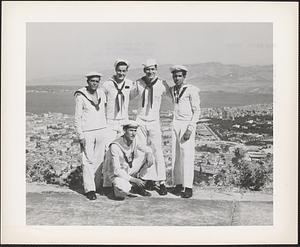 R. E. Burdick, storekeeper third class, and Stanley J. Finkel, seaman first class of the USS Leyte, are shown in the photograph, above, with three Turkish sailors while on liberty at Izmir, Turkey