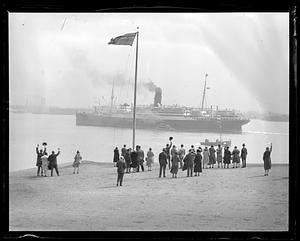 People waving to RMS Scythia