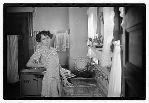A woman doing laundry at a sink